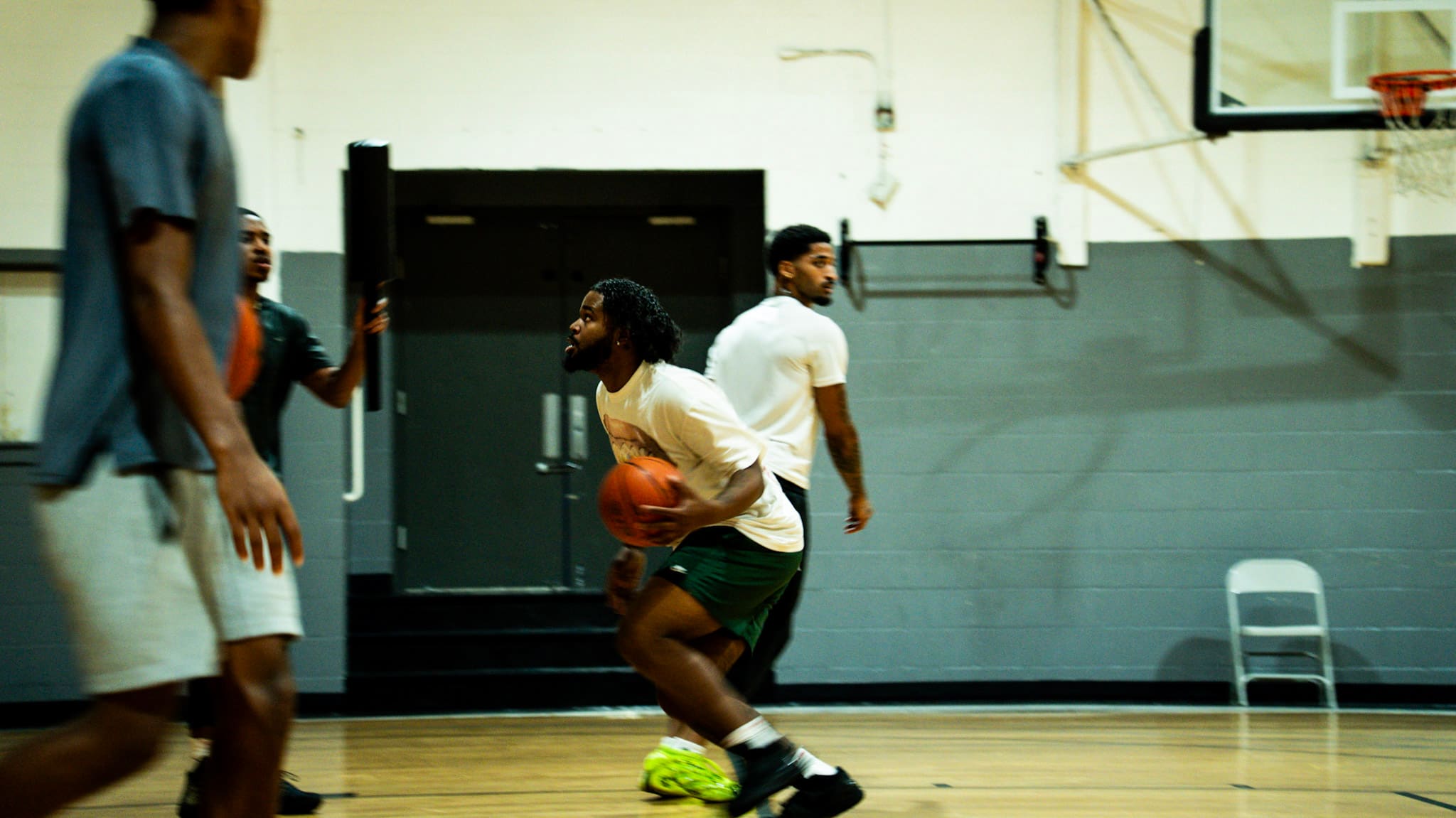 Basketball player driving across the court